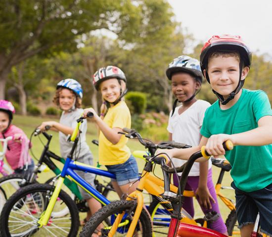 children side by side on bikes