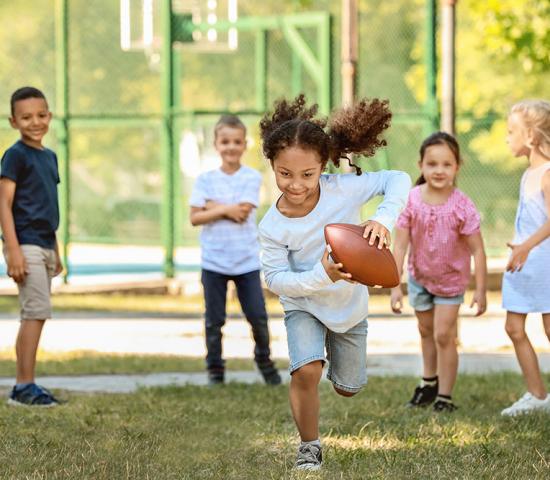 kid running with football