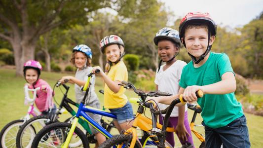 children side by side on bikes