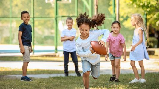 kid running with football